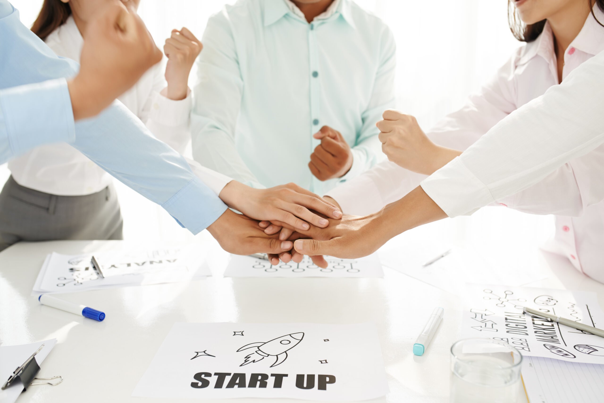 Startup business team stacking hands as a symbol of unity