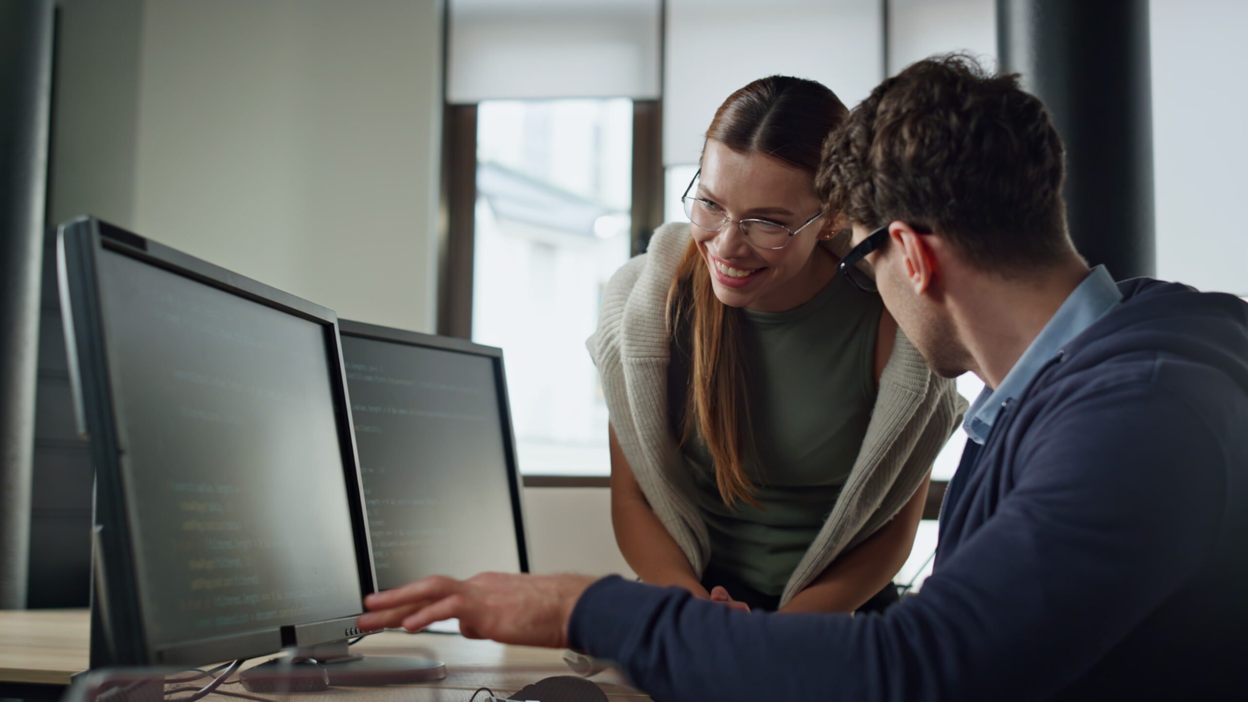 Two People Working on A Computer